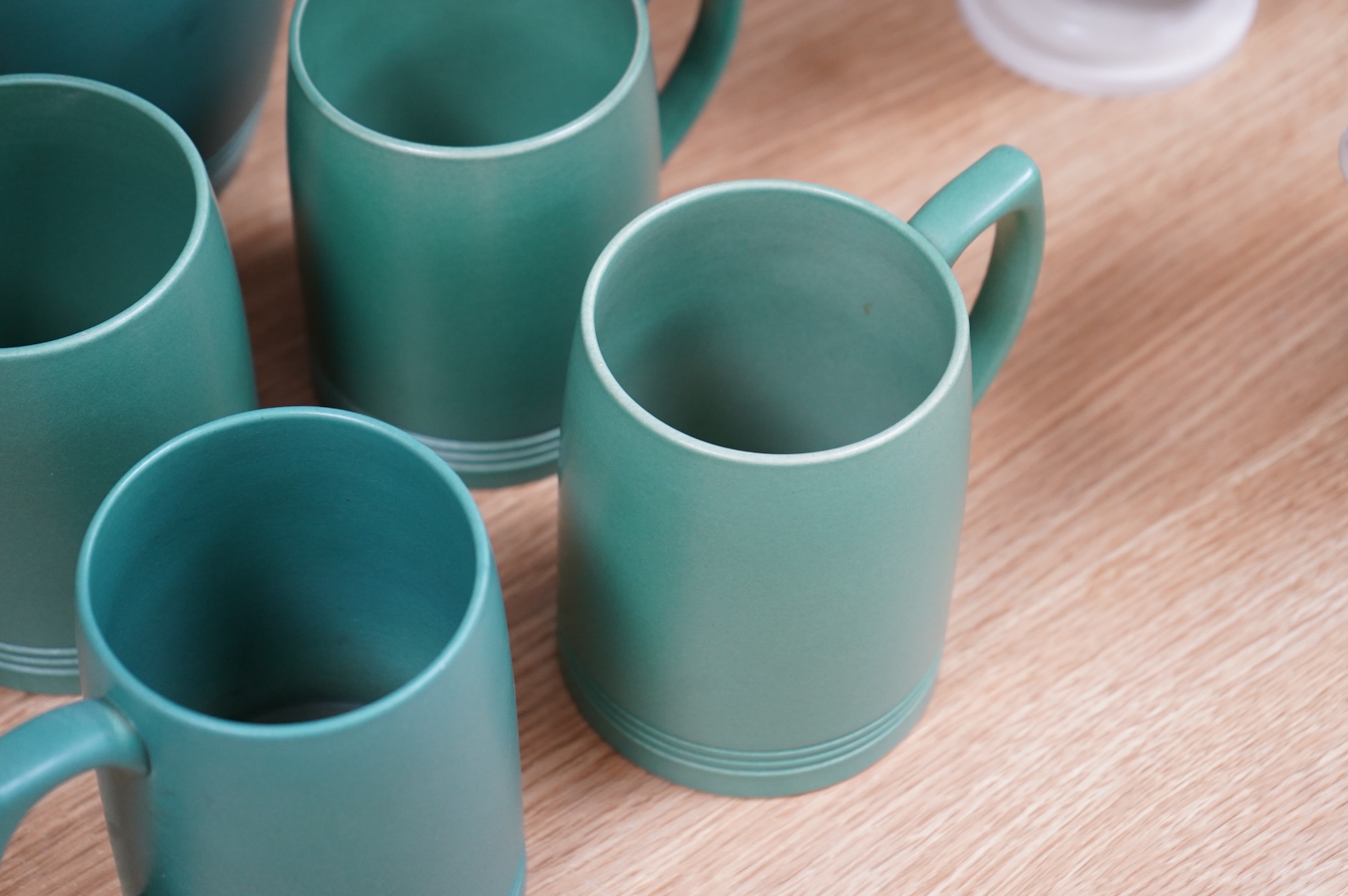 Keith Murray for Wedgwood green glazed lemonade jug and four green mugs, largest 21cm high